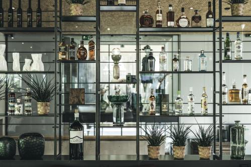 a shelf filled with lots of bottles of alcohol at Hotel Arlmont 4 Stern Superior in Sankt Anton am Arlberg