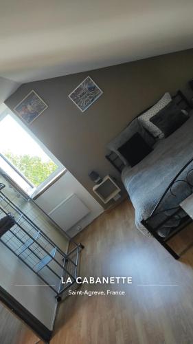 an overhead view of a room with a bed and a window at La Cabanette in Saint-Agrève