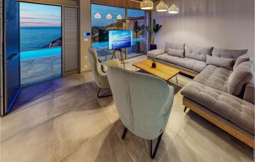 a living room with a couch and a table at 3 Bedroom Lovely Home In Gazi, Heraklio in Lygaria