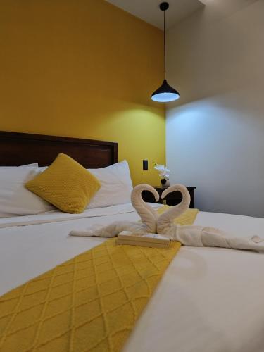 a bedroom with two towels in the shape of hearts at Plato De Ciudad II in Boracay
