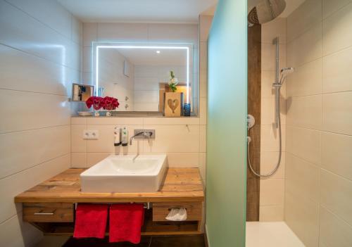 a bathroom with a sink and a shower at Helmerhof in Schwangau