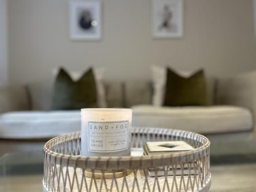 a candle on a table in a living room at Trevose in Wrexham