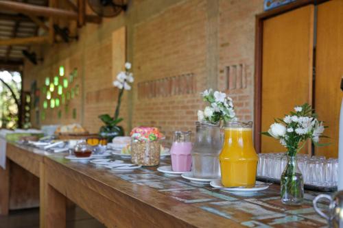 una mesa larga con platos de comida y bebida en Pousada Villa dei Colori, en Araraquara