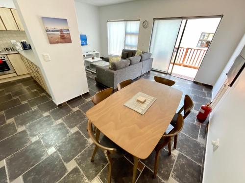 a living room with a table and a couch at Salty Sunset Self Catering in Langstrand