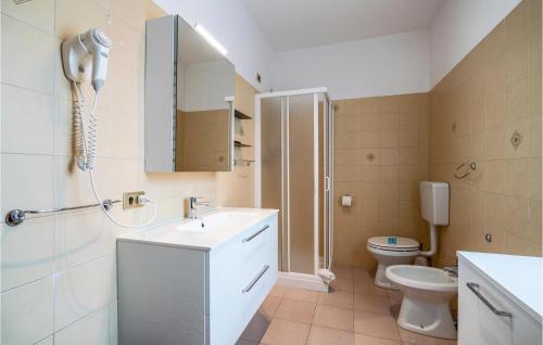 a bathroom with a sink and a toilet and a mirror at 3 Bedroom Gorgeous Home In Albarella Ro in Isola Albarella