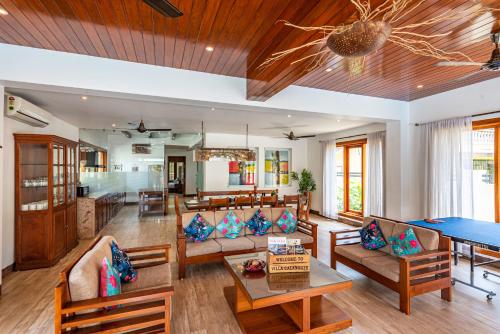 a living room with couches and a ping pong table at Villa Calangute Phase 11 in Calangute