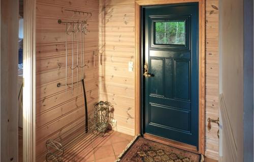 a blue door in a room with a wall at Nice Home In Lindesnes With Sauna in Svenevik