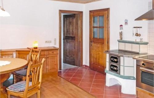a kitchen with a table and a table and chairs at Große Ferienwohnung Grossarl in Grossarl