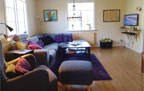 a living room with a couch and a table at Beautiful Home In Vilshult With Kitchen in Vilshult
