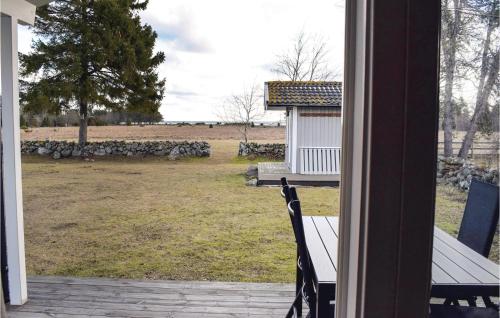 a view of a yard from a porch with a bench at Two-Bedroom Holiday Home In Lottorp in Löttorp