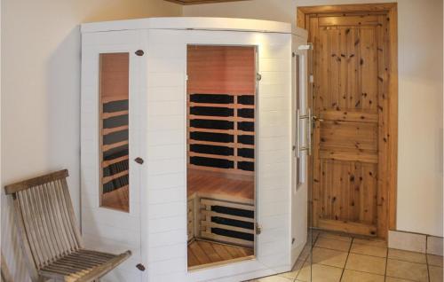 a wine cabinet in a room with a bench at Amazing Home In Köpingsvik With Sauna in Köpingsvik
