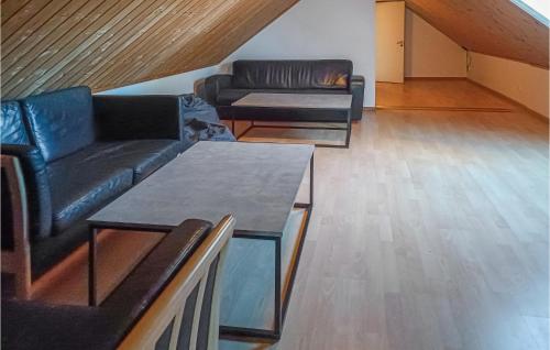 a living room with two couches and a table at Amazing Home In Köpingsvik With Sauna in Köpingsvik