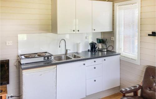 a kitchen with white cabinets and a sink at Beautiful Home In Kleppe With Wifi in Bore