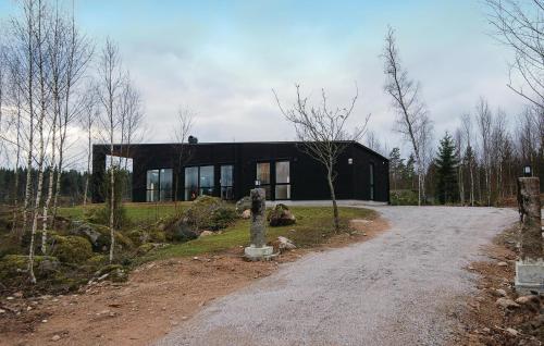 a black house sitting on top of a dirt road at Three-Bedroom Holiday Home Holmsjö With A Fireplace 06 in Holmsjö
