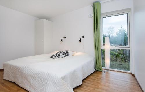 a white bedroom with a bed and a window at Three-Bedroom Holiday Home Holmsjö With A Fireplace 06 in Holmsjö