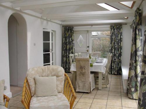 a dining room with a table and chairs at Ley Park in Bideford