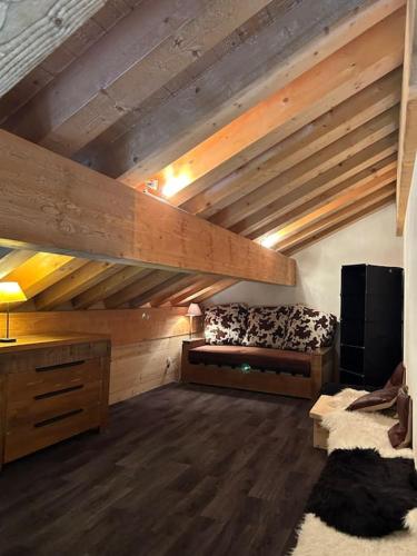Cette grande chambre dispose d'un lit et d'un plafond en bois. dans l'établissement Duplex famille 10 à 12 personnes station les coches La plagne, à La Plagne Tarentaise