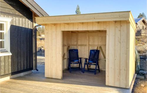 two chairs in a wooden shed on a deck at Beautiful Home In Engerdal With Kitchen in Kvisla