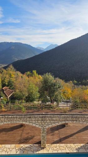 a stone bench with a view of a mountain at Villa Virginia Hotel in Karpenision