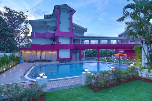 a house with a swimming pool in front of it at Imperial Grande Resort in Lonavala