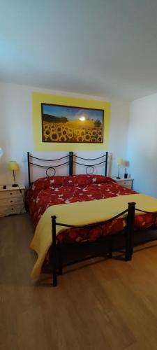 a bedroom with a bed with a red comforter at B&B Terramare in Montiano