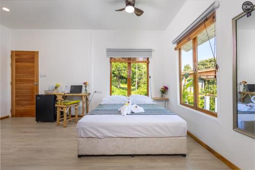 a bedroom with a bed with a stuffed animal on it at BOHO Boutique Bungalows in Baan Tai