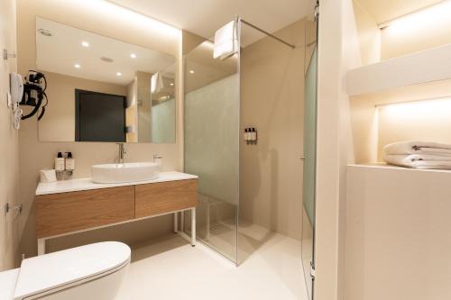 a bathroom with a toilet and a sink and a shower at Kamengrad Hotel & SPA in Panagyurishte