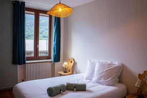 a bedroom with a bed with a stuffed animal on it at Le montagnard - Nature, parking in Albertville