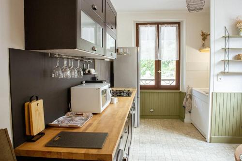 a kitchen with a counter top with a microwave at Le montagnard - Nature, parking in Albertville