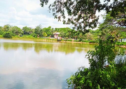 a view of a river with a house in the distance at Dinsara Villa Mirissa,Kamburugamuwa in Kamburugamuwa