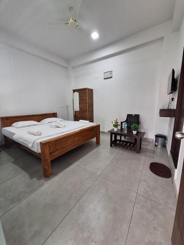 a bedroom with a large bed in a room at Vishalcomforts in Chikmagalūr
