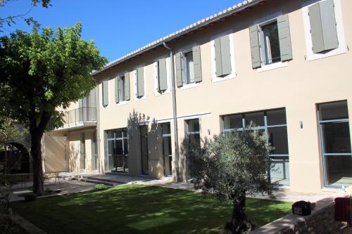 an office building with a lawn in front of it at La Magnanerie de l'Isle B&B in LʼIsle-sur-la-Sorgue