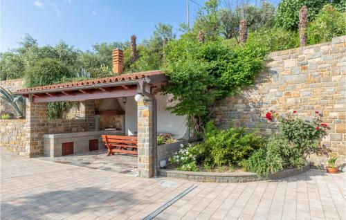 a stone wall with a bench and a brick wall at 1 Bedroom Amazing Apartment In Secovlje in Sečovlje