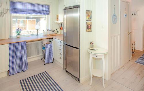 a kitchen with a stainless steel refrigerator and a table at Stunning Home In Höganäs With Wifi in Höganäs