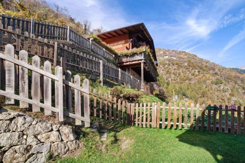 a fence in front of a building on a hill at Wohnung Naturns Ausergrubhof in Parcines