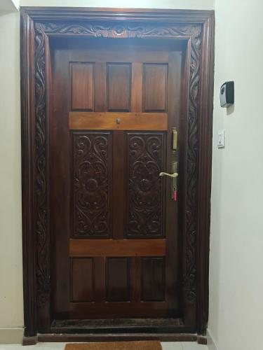a large wooden door in a room at Sri Vidya Palace in Udupi