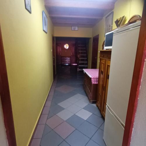 a hallway of a kitchen with a refrigerator at Usługi hotelarskie Karpacz in Karpacz