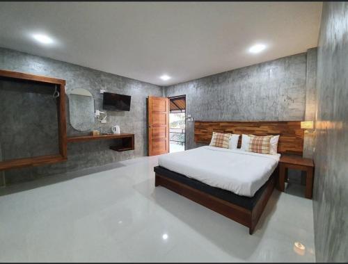 a bedroom with a bed and a chalkboard on the wall at Life koh tao resort in Koh Tao