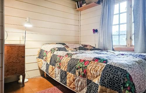 a bedroom with a bed and a window at 3 Bedroom Lovely Home In Mosvik in Mosvik