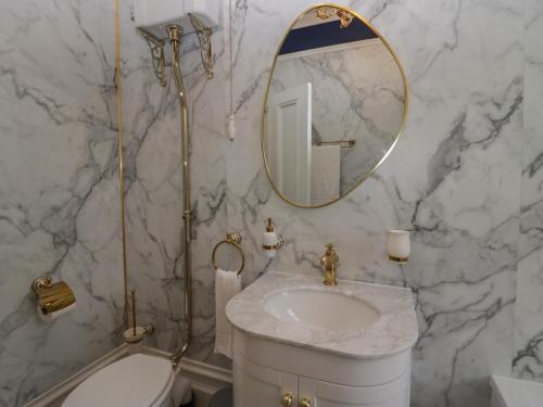 a bathroom with a sink and a mirror at Beechgrove Manor in Workington