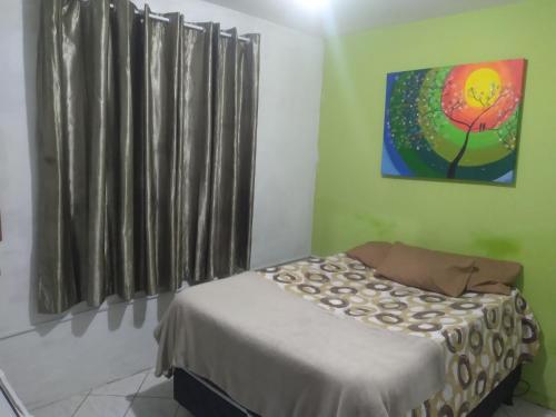 a bedroom with a bed and a painting on the wall at POUSADA BRASIL RECIFE in Recife
