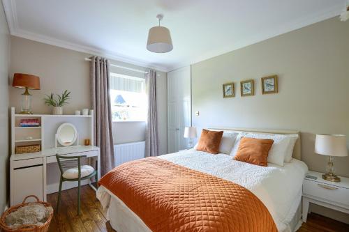 a bedroom with a bed and a desk with a mirror at Fox House Sleeps 8 w Parking 5 min to Kilmessan in Navan