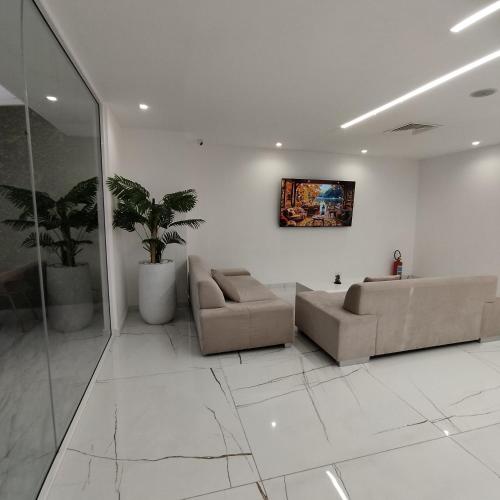 a living room with two couches and a painting on the wall at International Atene hotel in Athens