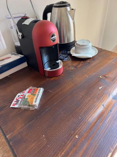 a coffee maker sitting on top of a wooden table at Le Scalette del centro in Agrigento