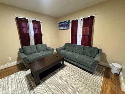 a living room with a couch and a coffee table at Ferry Getaway Home! in Niagara Falls