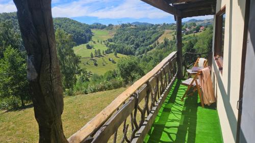 a balcony of a house with a view of a valley at Casa rustica in Braşov