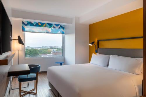 a hotel room with a bed and a window at Tru By Hilton Cali Sur in Cali