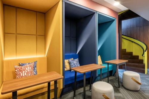 a restaurant with two tables and two stools at Tru By Hilton Cali Sur in Cali