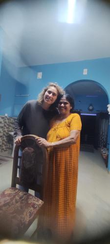 two women are hugging each other in a chair at Munnar Village Homes in Munnar