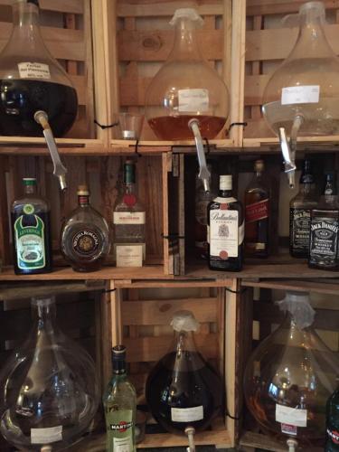 a shelf filled with lots of bottles of alcohol at Hotel Hoppe in Witten
